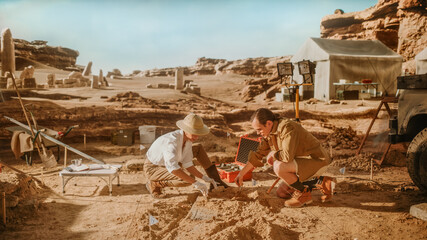 Archeological Digging Site: Two Great Archeologists Work on Excavation Site, Carefully Cleaning...
