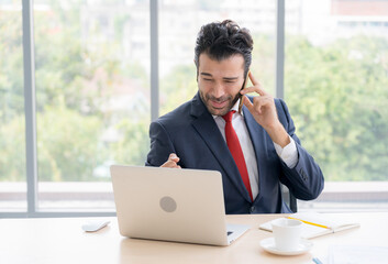 Business man  is on the call to discuss about business progress and project. He has a happy face and his project is success
