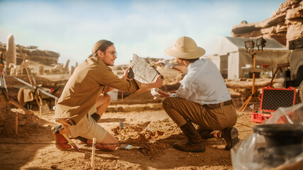 Archeological Digging Site: Two Great Archeologists Work on Excavation Site, Carefully Holding...