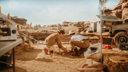 Archaeological Digging Site: Great Female Archeologist Work on Excavation Site, Carefully Cleaning...