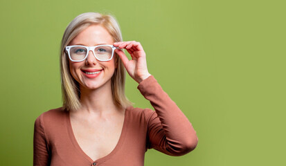 Beautiful blonde girl in a glasses and brown blouse