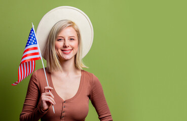 Beautiful cowgirl in a hat with United States of America flag