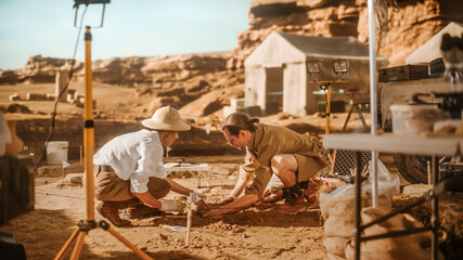Archeological Digging Site: Two Great Archeologists Work on Excavation Site, Cleaning Cultural...