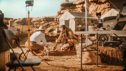 Archeological Digging Site: Two Great Archeologists Work on Excavation Site, Carefully Cleaning,...