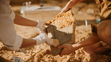 Archeological Digging Site: Two Great Archeologists Work on Excavation Site, Carefully Cleaning,...