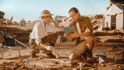 Archaeological Digging Site: Two Great Paleontologists Use Tablet Computer to Analyse Skeleton of...