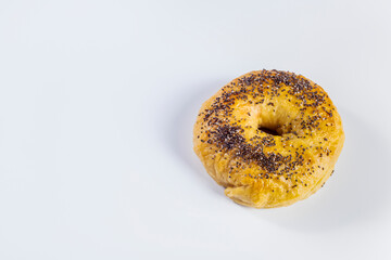 Freshly made and baked bagel on white background. Homemade cooking and pastry concept. Horizontal photo and selective focus