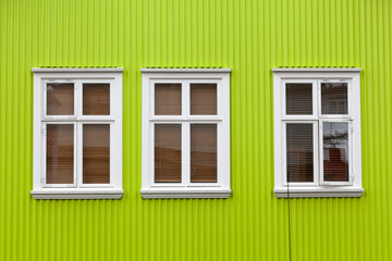 Windows on the bright green wall, Reykjavik, Iceland