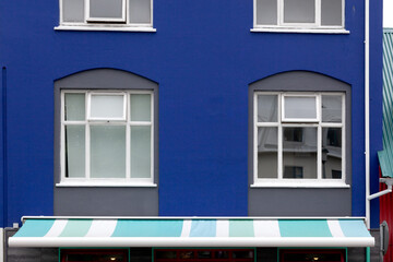 Windows on the bright blue wall, Reykjavik, Iceland