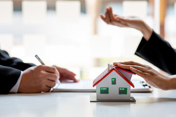 Real estate broker agent presenting and consult to customer to decision making sign insurance form...