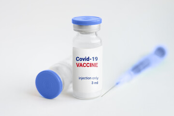 Coronavirus vaccine. Ampoules and syringe on a white background