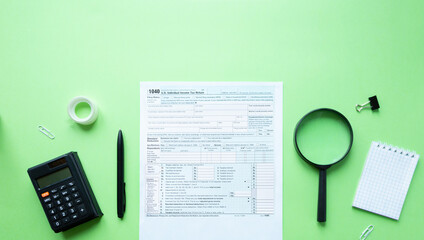1040 individual tax form. Pen, calculator, notepad and magnifier. Tax concept. With space for text