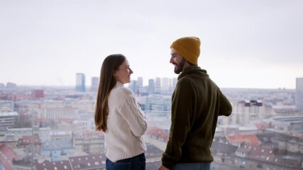 Rear view of young couple owners with coffee on balcony in new flat, moving in, new home and relocation concept.