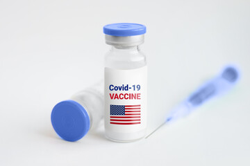 Vaccination coronavirus in America concept. Ampoule with injection from covid-19 on a white background and a syringe