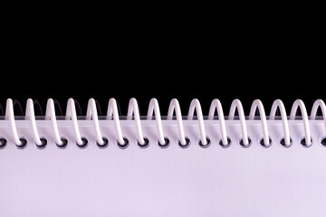 Notebook spiral spines on black background