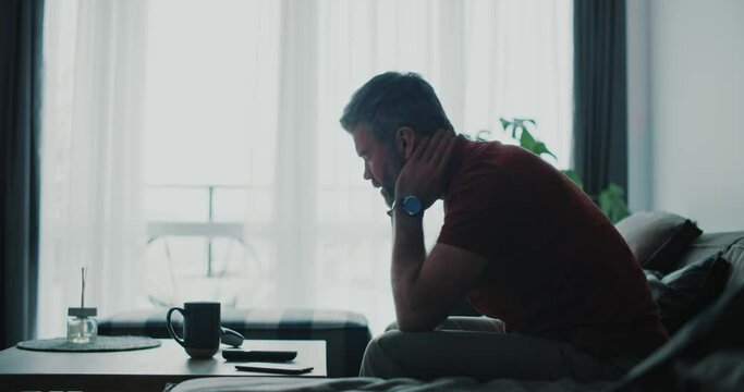 Stressful millennial adult caucasian man frustrating over a problem, having trouble with business losing money enterprise, staying home in depression.