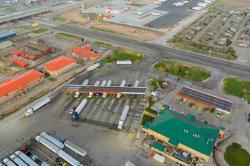 Drone view of the automotive large over road semi-trucks at fueling station