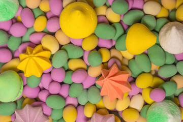Fototapeta na wymiar Colorful meringues and glazed peanuts isolated on a white background.