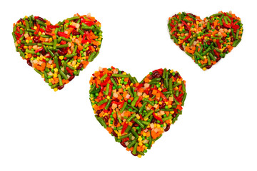 Heart made of vegetables. Corn, carrot, bell pepper, green beans. Isolated on white.