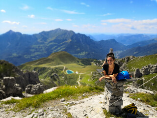 Naklejka na ściany i meble Young Woman looks at the stunning panorama after the climbing - Piani di Bobbio