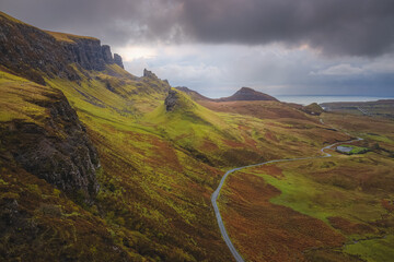 Moody, dramatic landscape view of the rugged, otherworldly terrain of the Quiraing on the Isle of Skye, Scotland.