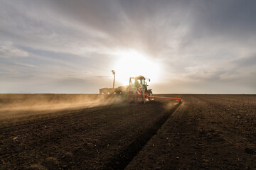 Farmer with tractor seeding