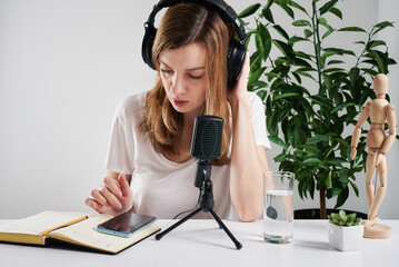 Woman in headphones listen audio cource.