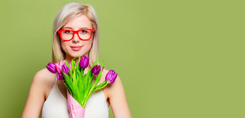 Surprised blonde girl with tulips