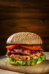 Close up of home made delicious burger on a wooden table.