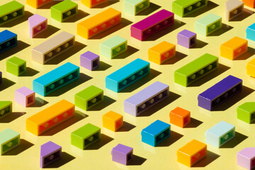 Fototapeta na wymiar Colorful plastic brickes background with sun light. Building bussines concept.