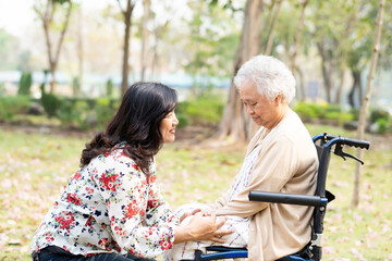 Asian senior or elderly old lady woman patient with care, help and support happy on wheelchair in park in holiday, healthy strong medical concept.