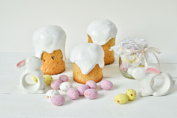 Easter sweets and decorations background. Traditional sweet cake with colorful painted eggs, easter Bunny and decor.