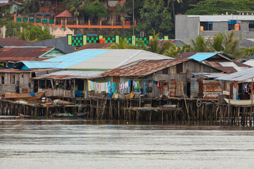 Skyline of humble little houses by the sea in the town of Sorong, West Papua, near the arrival area of the Waisai to Sorong ferry.