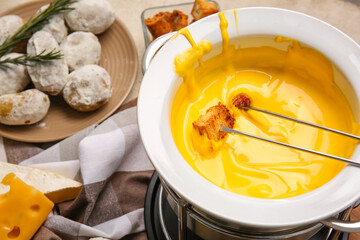 Stick with crouton dipped into cheese fondue, closeup