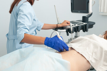 Naklejka na ściany i meble Ultrasound examination of kidneys. Diagnostics of the lower back with an ultrasound machine