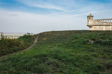 Fototapeta na wymiar Renaissance castle in Ukraine. Castle tower against blue sky background
