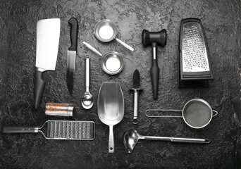 Set of kitchen utensils and spices on dark background
