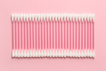 Cotton swabs on color background
