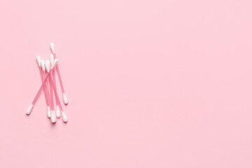 Cotton swabs on color background