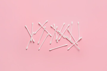 Cotton swabs on color background