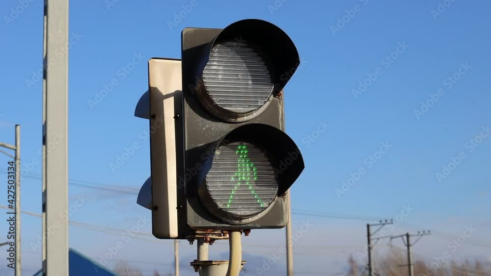 Poster traffic lights with a permitting green signal on the railway