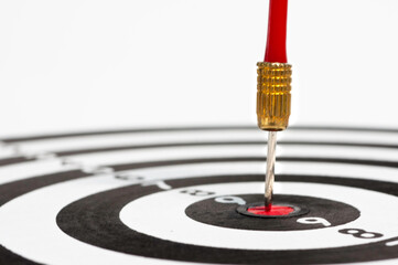 Red arrow hit on target dart board, business strategy planning to success goal.