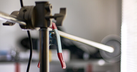 Fototapeta na wymiar Close-up of red clamp on C-stand inside a photo studio