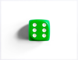 Number 6 on green dice. White background.