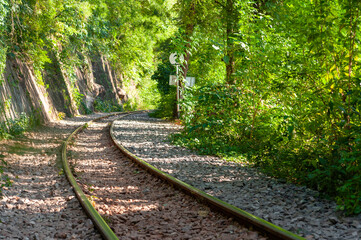 Part of the death railway, The railway train track runs along a hill through green forests and rivers.