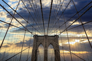 Brooklyn Bridge against cloudy sky at sunset. New York city, Manhattan. US