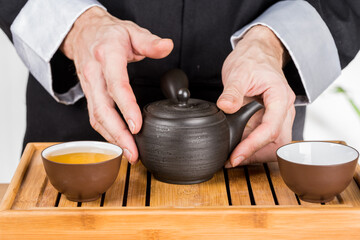 preparation of green loose tea in traditional Japanese ceramics