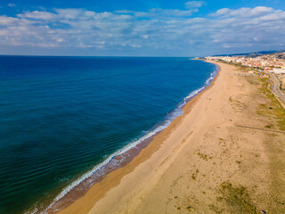 Aerial images with drone of Malgrat de Mar beach in Maresme Barcelona European tourism Spectacular cinematic plane aerial view turquoise water