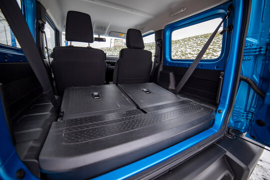 Side View Of Empty Open Car Trunk With Seats Folded Into Flat Flor Of Suv Crossover. Open Door