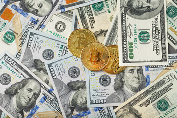 Gold bitcoin coins on the background of dollar bills with the concept of the exchange rate of the financial markets.